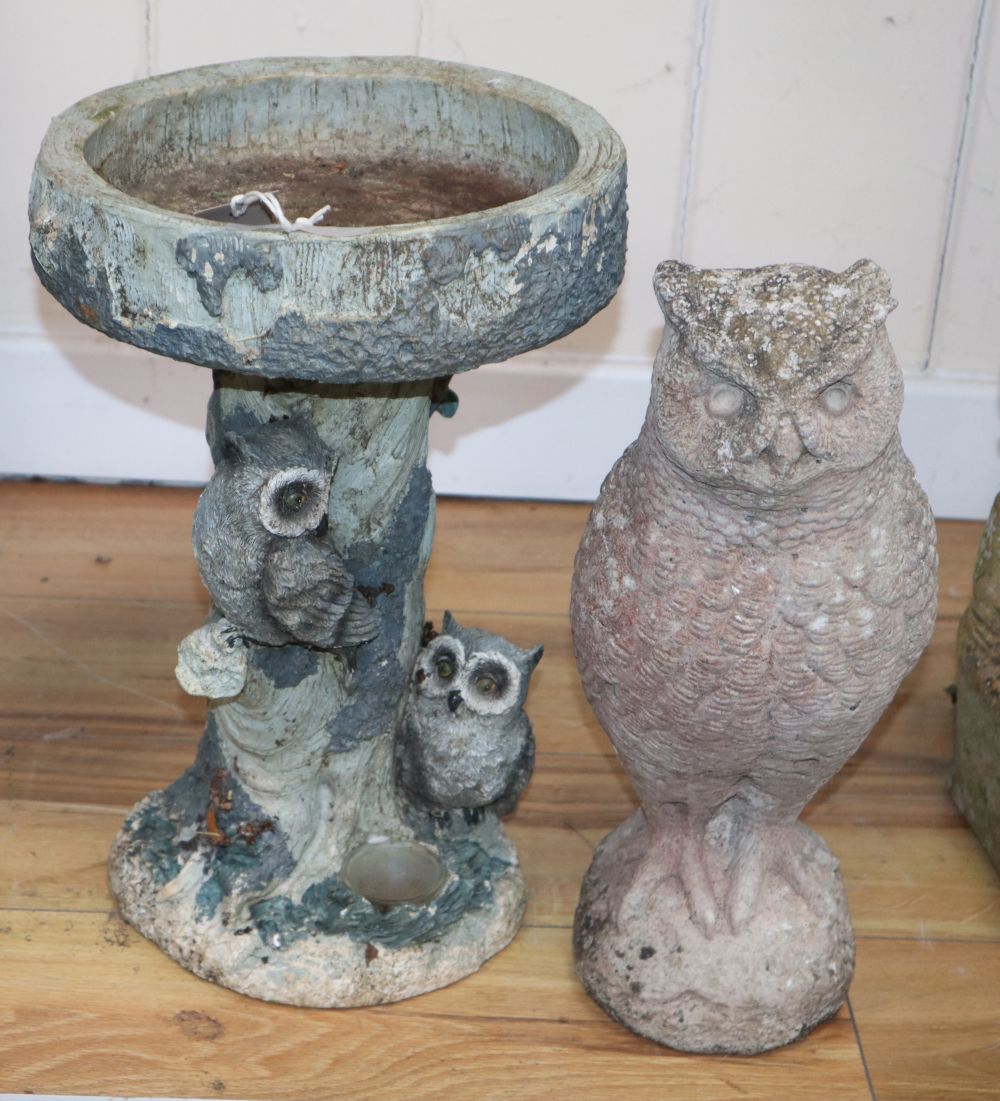 A reconstituted stone garden ornament of an owl, H.38cm, together with a composition bird bath